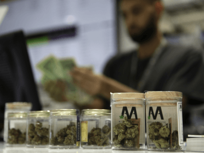 n this July 1, 2017 file photo, a cashier rings up a marijuana sale at the Essence cannabis dispensary in Las Vegas. A medical marijuana patient is asking the Nevada Supreme Court to reconsider its refusal to end mandatory state registration and fees for medical pot cards now that marijuana …