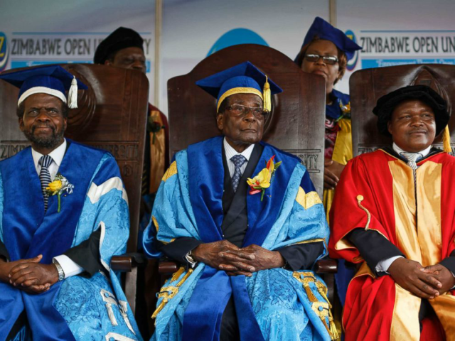 Zimbabwe's President Robert Mugabe, center, sits for formal photographs with university of