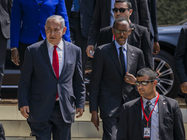 Israeli Prime Minister Benjamin Netanyahu, left, and Rwandas President, Paul Kagame , right, arriving at the Kigali Memorial Center, Kigali, Rwanda, Wednesday, July 6, 2016. Netanyahu is on a one day visit to Rwanda during a four-nation Africa tour.( AP Photo)