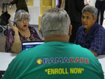 MIAMI, FL - NOVEMBER 01: Isabel Diaz Tinoco (L) and Jose Luis Tinoco speak with Otto Hernandez, an insurance agent from Sunshine Life and Health Advisors, as they shop for insurance under the Affordable Care Act at a store setup in the Mall of Americas on November 1, 2017 in …