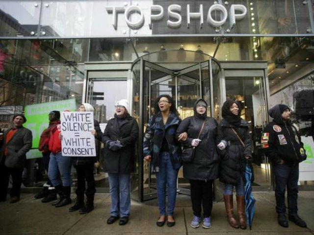 Demonstrators block the entrance of Top Shop as they protest the shooting of Laquan McDona