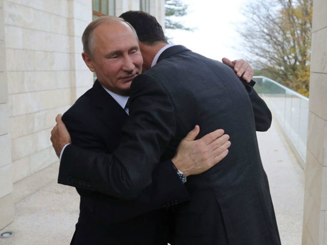 Russia's President Vladimir Putin (L) embraces his Syrian counterpart Bashar al-Assad during a meeting in Sochi on November 20, 2017. / AFP PHOTO / SPUTNIK / Mikhail KLIMENTYEV (Photo credit should read MIKHAIL KLIMENTYEV/AFP/Getty Images)