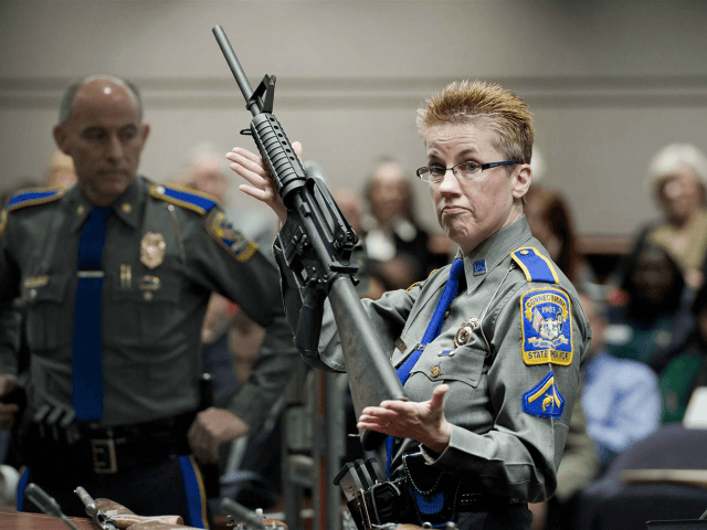 FILE - In this Jan. 28, 2013, file photo, firearms training unit Detective Barbara J. Mattson, of the Connecticut State Police, holds up a Bushmaster AR-15 rifle, the same make and model of gun used by Adam Lanza in the Sandy Hook School shooting, for a demonstration during a hearing …