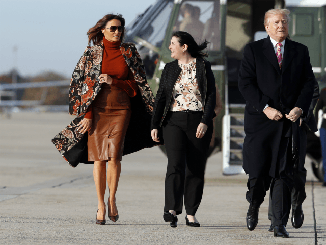 First lady Melania Trump, left, walks with President Donald Trump, as they board Air Force