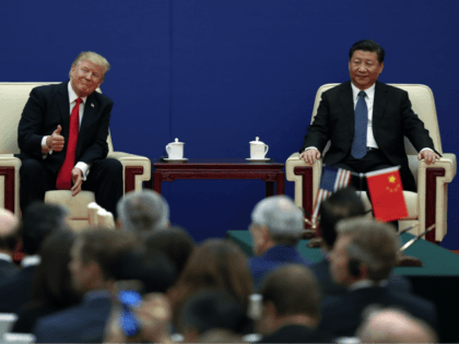 U.S. President Donald Trump gestures to his delegation next to and Chinese President Xi Jinping during a business event at the Great Hall of the People in Beijing, Thursday, Nov. 9, 2017. Trump is on a five-country trip through Asia traveling to Japan, South Korea, China, Vietnam and the Philippines. …