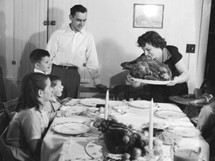 circa 1955: A Thanksgiving turkey comes to the table watched by the family. (Photo by Evans/Three Lions/Getty Images)