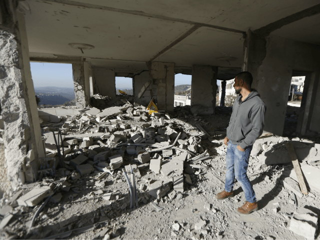 A Palestinian man inspects apartment of Nimr Jamal after it was demolished by the Israeli army in the West Bank village of Beit Surik near Jerusalem, Wednesday, Nov. 15, 2017. Jamal killed the three Israelis and critically wounded a fourth outside the West Bank settlement of Har Adar before he …
