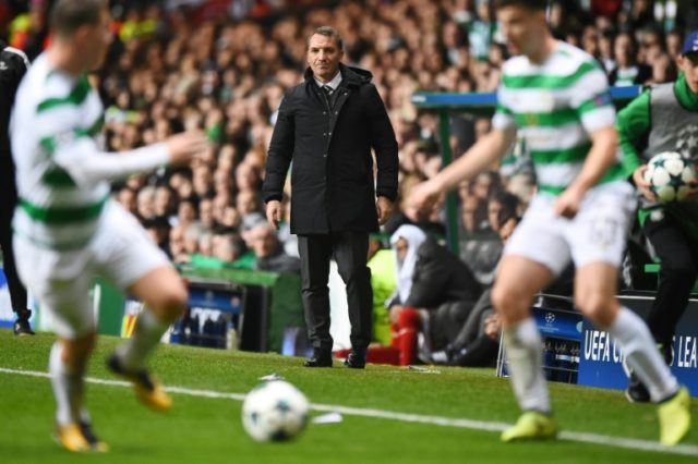 Celtic's manager Brendan Rodgers (C) watches their UEFA Champions League match against Bay