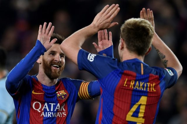 Barcelona's midfielder Ivan Rakitic (R) celebrates with forward Lionel Messi after scoring