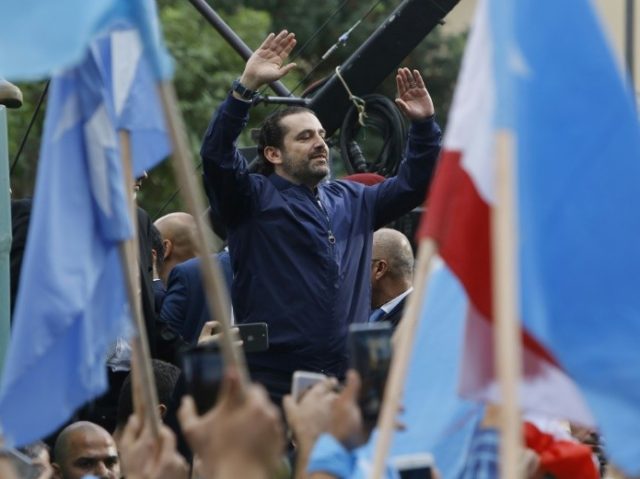 Lebanese Prime Minister Saad Hariri greets cheering supporters outside his home in Beirut