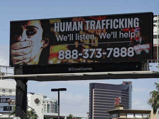 FILE - In this Thursday, Sept. 21, 2017 photo, a billboard displays a phone number for the