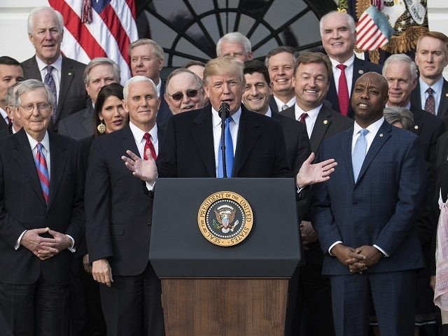 President Donald Trump joined by Senate Majority Leader Mitch McConnell of Ky., Vice President Mike Pence, Speaker of the House Paul Ryan, R-Wis., Sen. Tim Scott, R-S.C., front right, and other members of congress, speaks during an event on the South Lawn of the White House in Washington, Wednesday, Dec. …