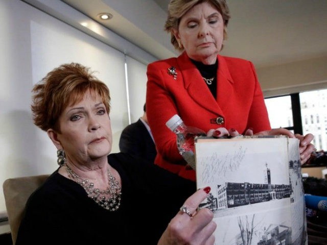 Beverly Young Nelson, left, and attorney Gloria Allred hold Nelson’s high school yearbook, which they say was signed by Senate candidate Roy Moore, at a news conference in New York on Monday. (Richard Drew/AP)