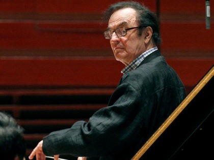FILE- In this Oct. 19, 2011 file photo, world-renowned conductor Charles Dutoit, right, pe