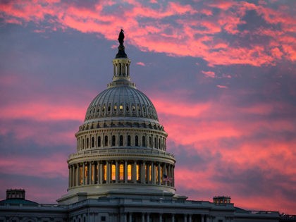 FILE - In this Thursday, Nov. 30, 2017, file photo, the sky over The Capitol is lit up at dawn as Senate Republicans work to pass their sweeping tax bill, in Washington. Congress' last major tax overhaul, three decades ago, was everything this year’s version isn’t. The Tax Reform Act …