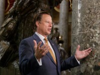 Rep. Dave Brat, R-Va., a member of the conservative Freedom Caucus, explains his position to a TV interviewer before his group met with President Donald Trump as the GOP's long-promised legislation to repeal and replace "Obamacare" moves to a showdown vote, Thursday, March 23, 2017, on Capitol Hill in Washington. …