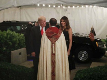 President Donald Trump and first lady Melania are greeted by the Rev. James R. Harlan as they arrive for Christmas Eve service at the Church of Bethesda-by-the-Sea in West Palm Beach, Fla., Sunday, Dec. 24, 2017. (AP Photo/Carolyn Kaster)