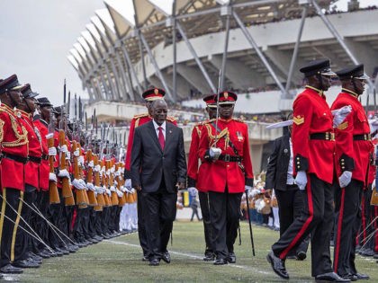 Tanzania's newly elected president John Magufuli (C, L) reviews troops during the swearing in ceremony in Dar es Salaam, on November 5, 2015. John Magufuli won in the October 25 poll with over 58 percent of votes cemented the long-running Chama Cha Mapinduzi (CCM) party's firm grip on power.. AFP …