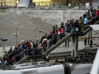 Police organize the line of refugees on the stairway leading up from the trains arriving from Denmark at the Hyllie train station outside Malmo, Sweden, November 19, 2015. 600 refugees arrived in Malmo within 3 hours and the Swedish Migration Agency said in a press statement that they no longer …