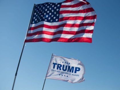 An American Flag and a Donald Trump flag wave outside a Donald Trump rally at Millington Regional Jetport on February 27, 2016 in Millington, Tennessee. / AFP / Michael B. Thomas (Photo credit should read MICHAEL B. THOMAS/AFP/Getty Images)