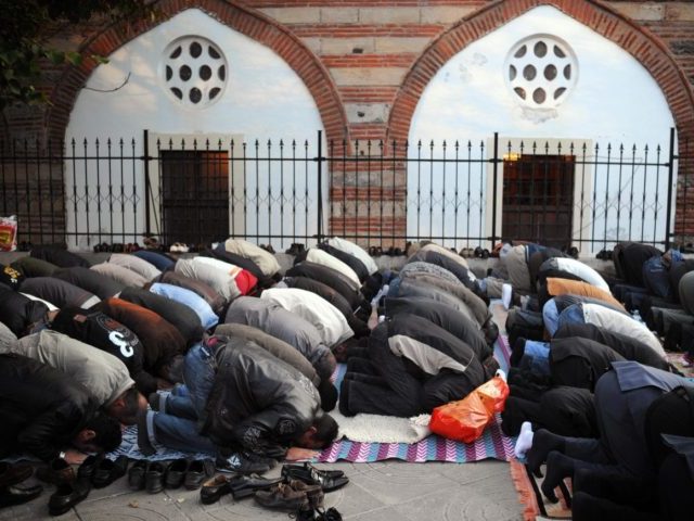 Muslim worshippers pray in front of a mosque in downtown Sofia on September 30, 2008, as t