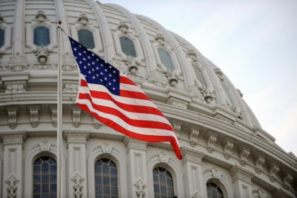 The US flag flies at the US Capitol in Washington, DC, January 20, 2009. Millions of peopl