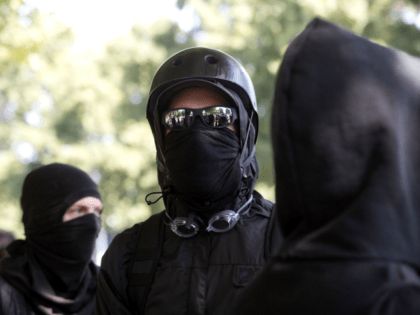 Antifa protesters wear bandanas over their face during a protest to oppose the right wing group 'The Patriot Prayer Movement,' that was having a rally in downtown Portland, Oregon on September 10, 2017. Several hundred protesters descended in to downtown Portland to oppose the right-wing group. / AFP PHOTO / …
