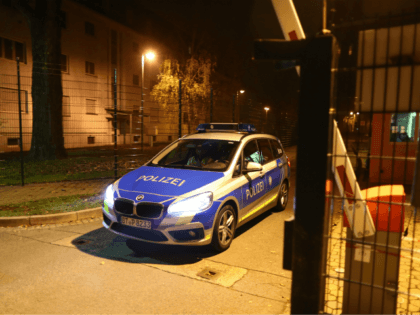 A police car leaves the grounds of a reception centre for asylum seekers in Bamberg, southern Germany, on early November 15, 2017. A man was killed and 14 residents of the home were injured as a fire broke out. The cause of the fire is yet unclear. / AFP PHOTO …