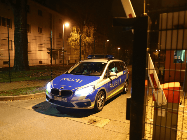 A police car leaves the grounds of a reception centre for asylum seekers in Bamberg, southern Germany, on early November 15, 2017. A man was killed and 14 residents of the home were injured as a fire broke out. The cause of the fire is yet unclear. / AFP PHOTO …