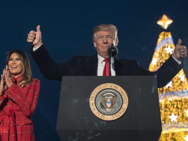 US President Donald Trump (R) gestures as First lady Melania Trump smiles during the 95th