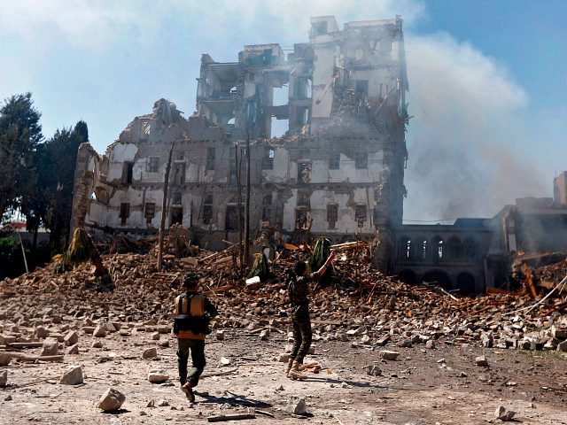 Huthi rebel fighters inspect the damage after a reported air strike carried out by the Saudi-led coalition targeted the presidential palace in the Yemeni capital Sanaa on December 5, 2017. Saudi-led warplanes pounded the rebel-held capital before dawn after the rebels killed former president Ali Abdullah Saleh as he fled …