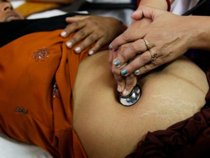 In this Oct. 22, 2011 file photo, a doctor examines a pregnant woman at the district women's hospital, in Allahabad, in India's most populous state of Uttar Pradesh. India’s government is advising pregnant women to avoid all meat, eggs and lusty thoughts. Doctors say the advice is preposterous, and even …