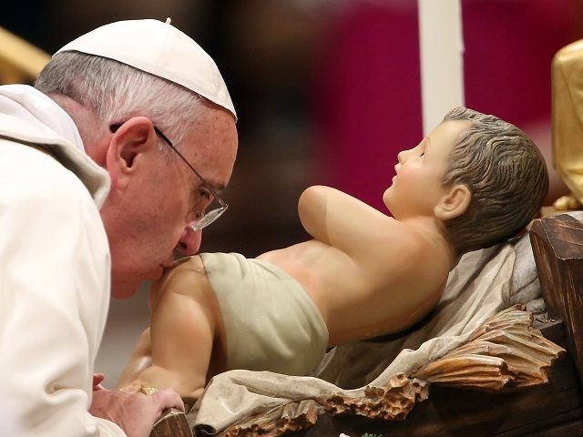 VATICAN CITY, VATICAN - DECEMBER 24: Pope Francis kisses the crib as he attends Christmas night mass at the St. Peter's Basilica on December 24, 2013 in Vatican City, Vatican. Pope Francis celebrates the first Christmas of his pontificate. (Photo by Franco Origlia/Getty Images)