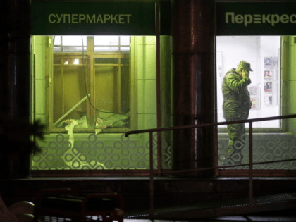 An investigator speaks on the phone inside a supermarket after an explosion in St.Petersburg on Wednesday. (Dmitri Lovetsky/AP)