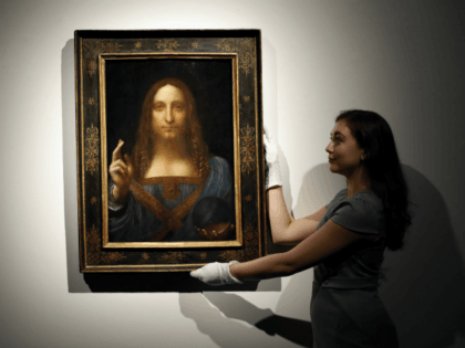 An employee poses with Leonardo da Vinci's 'Salvator Mundi' on display at Christie's auction rooms, in London, Tuesday, Oct. 24, 2017. The painting will be sold in the Post-War and Contemporary Art Evening Auction taking place on Nov.15 at Christie's New York. The estimate is in the region of 100 …