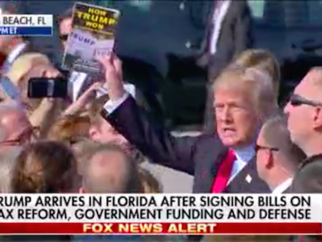 Donald Trump holds up "How Trump Won" (Screenshot / Fox News)
