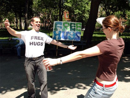 NEW YORK - MAY 16: Jayson Littman spreads his arms as he prepares to hug a woman May 16, 2