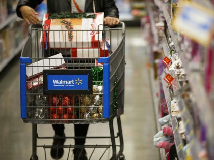 A customer pushes a shopping cart at a Wal-Mart Stores Inc. location in Burbank, California, U.S., on Tuesday, Nov. 22, 2016. Consumer hardline retailers are hopeful Black Friday will provide a strong start to the holiday shopping season, but any lift may come at the expense of margins, as the …