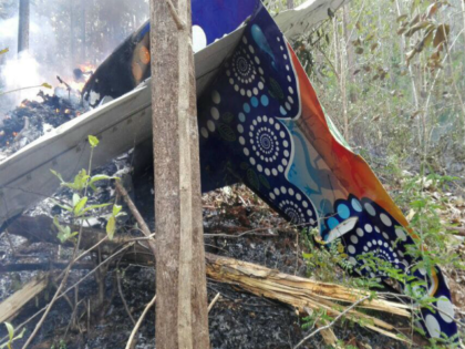 This photo released by Costa Rica's Public Safety Ministry shows people standing at the site of a plane crash near in Punta Islita, Guanacaste, Costa Rica, Sunday, Dec. 31, 2017. A government statement says there were 10 foreigners and two Costa Rican crew members aboard the plane belonging to Nature …