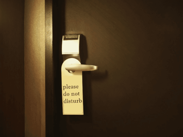 Hotel Door with Do Not Disturb Sign, Close-Up