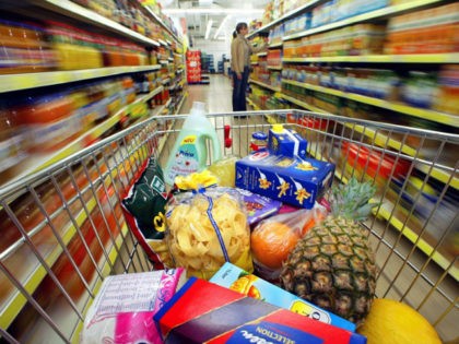 dpa) - A shopping cart with groceries and household supplies stands in a supermarket in Du