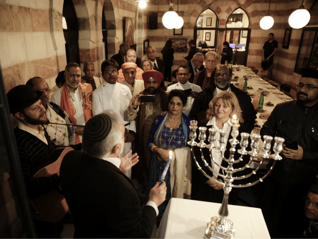 An interfaith group from the Gulf state of Bahrain attend Hannukah candle lighting in Jeru