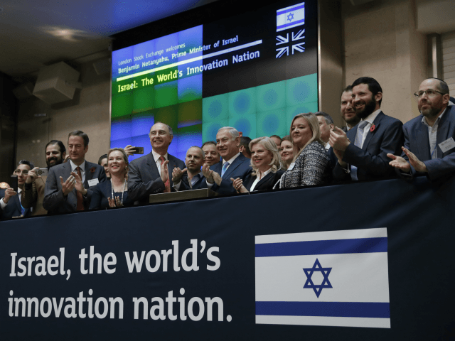 Israeli Prime Minister Benjamin Netanyahu, center right, takes part in a welcome ceremony for him at the London Stock Exchange in the City of London, Friday, Nov. 3, 2017. (AP Photo/Matt Dunham)