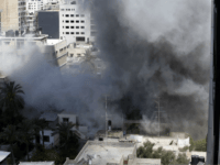 Smoke rises after an Israeli missile strike in Gaza City, northern Gaza Strip, Friday, July 18, 2014. Israel launched a ground invasion in Gaza, escalating a 10-day campaign of heavy air bombardments to try to destroy Hamas' rocket-firing abilities and the tunnels militants use to infiltrate Israel. (AP Photo/Lefteris Pitarakis)
