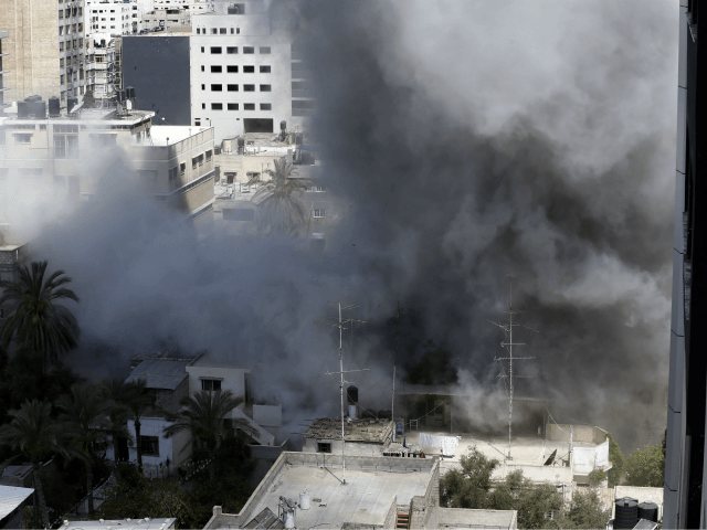Smoke rises after an Israeli missile strike in Gaza City, northern Gaza Strip, Friday, Jul
