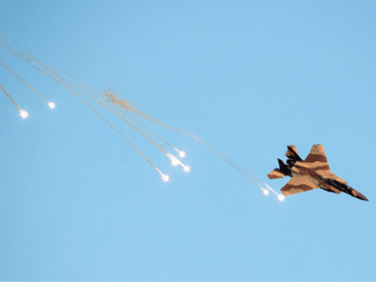 An Israeli F-15 I fighter jet launches anti-missile flares during an air show at the graduation ceremony of Israeli air force pilots at the Hatzerim base in the Negev desert, near the southern Israeli city of Beer Sheva, on June 30, 2016. / AFP / JACK GUEZ (Photo credit should …