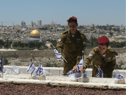 Israeli soldiers place flags on the graves of Jews killed in the battle for Jerusalem during Israel's 1948 War of Independence, on the eve of Memorial Day, Yom Hazikaron, at a small military cemetery on the Mount of Olives on May 6, 2008 in Jerusalem. Israel will remember its 22,437 …