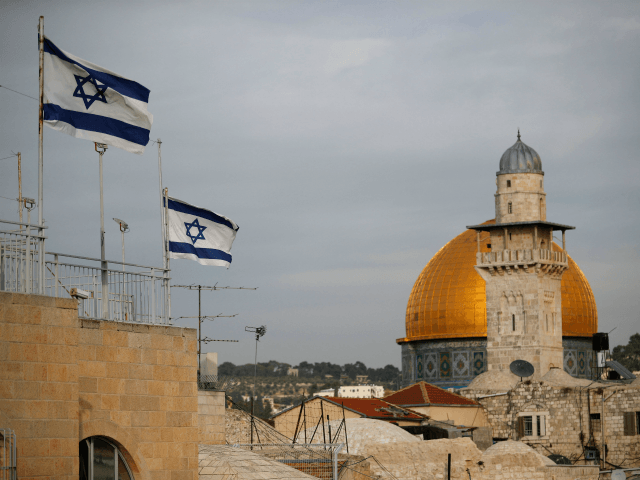 Israeli flags fly near the Dome of the Rock in the Al-Aqsa mosque compound on December 5, 2017. The EU's diplomatic chief Federica Mogherini said that the status of Jerusalem must be resolved 'through negotiations', as US President Donald Trump mulls recognising the city as the capital of Israel. / …