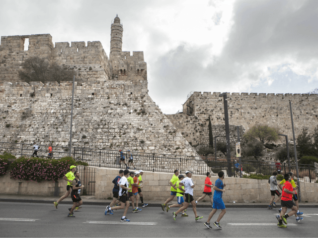 Runners pass the Tower of David as they participate in the annual marathon in Jerusalem, F
