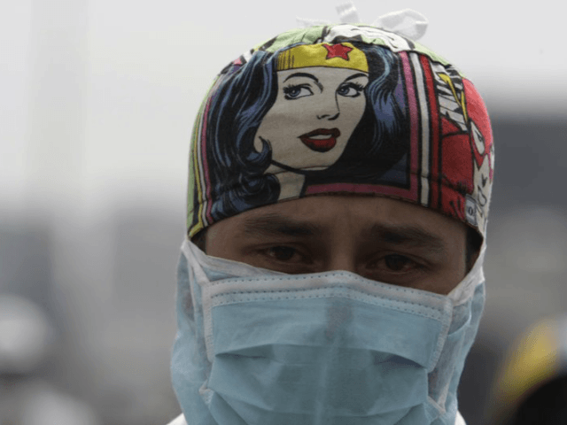 A medical professional wears his scrubs during an anti-government protest demanding Venezu